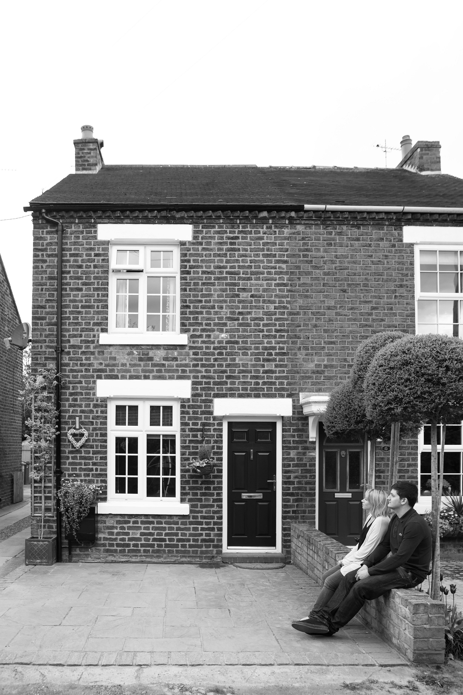 Couple sitting outside new home 