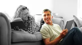 Couple on the sofa reviewing their finances