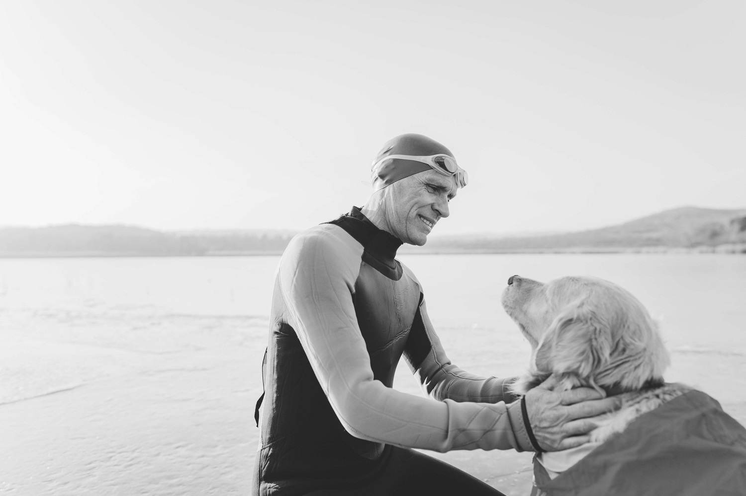 Person and golden retriever at beach 