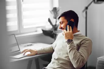 Person on call looking at laptop