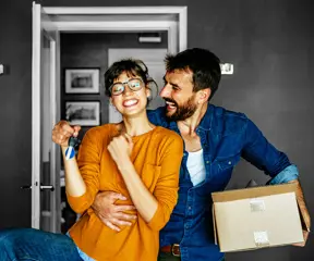 Happy couple moving into their new home