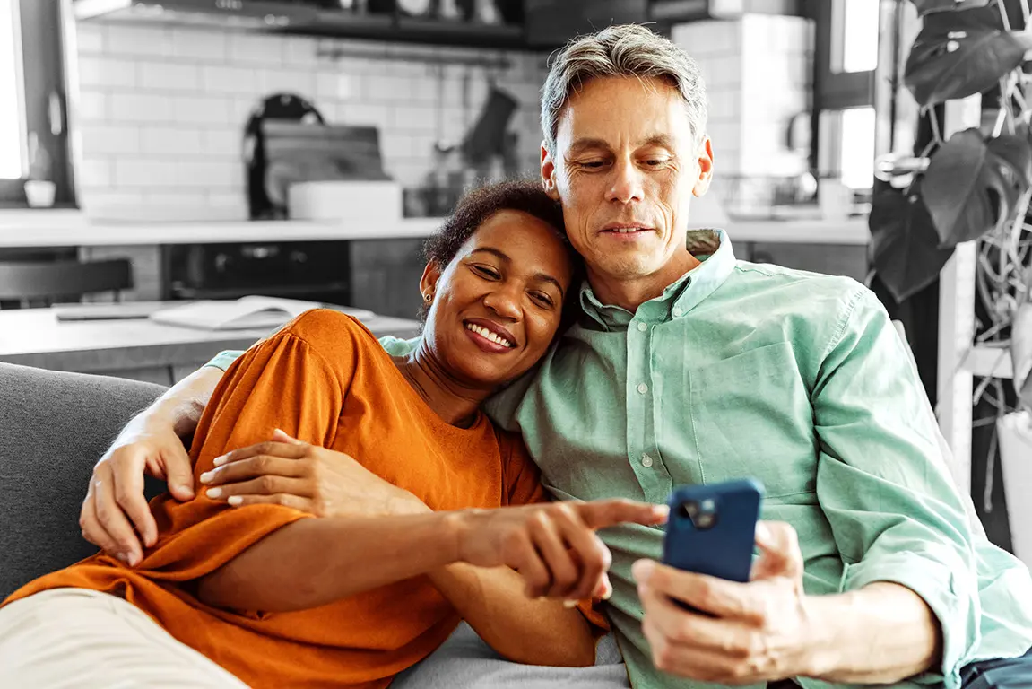 Happy couple looking at something on a phone