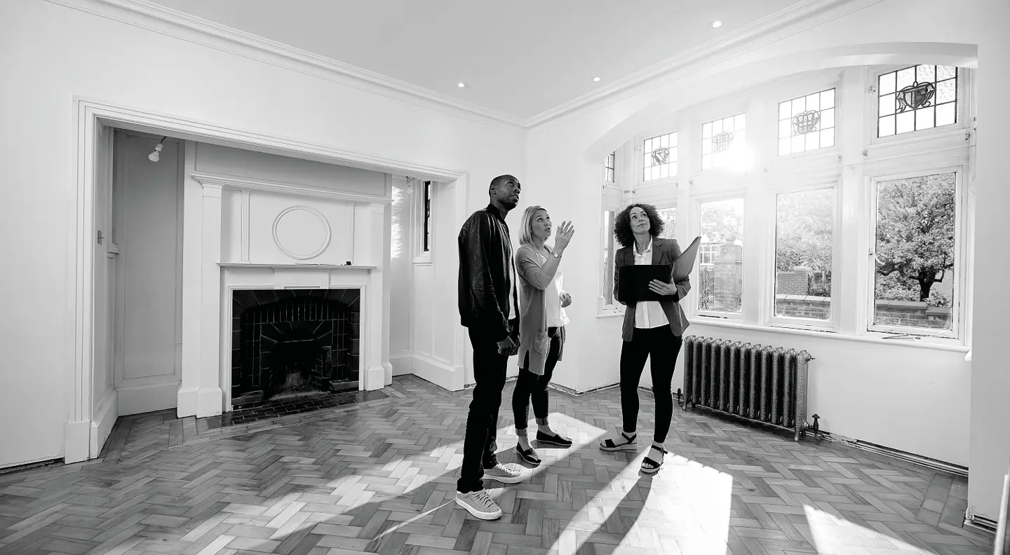 First time buyers viewing home with estate agent 