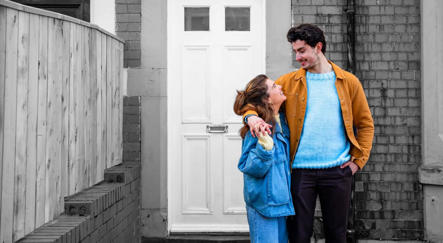 Young couple outside their new home
