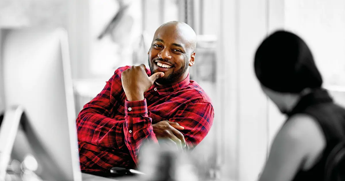 Person smiling at desk 