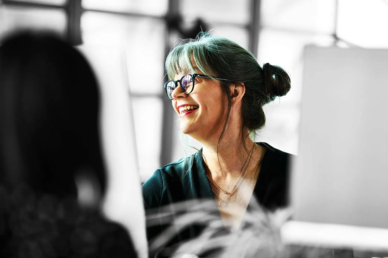 Person smiling at desk 
