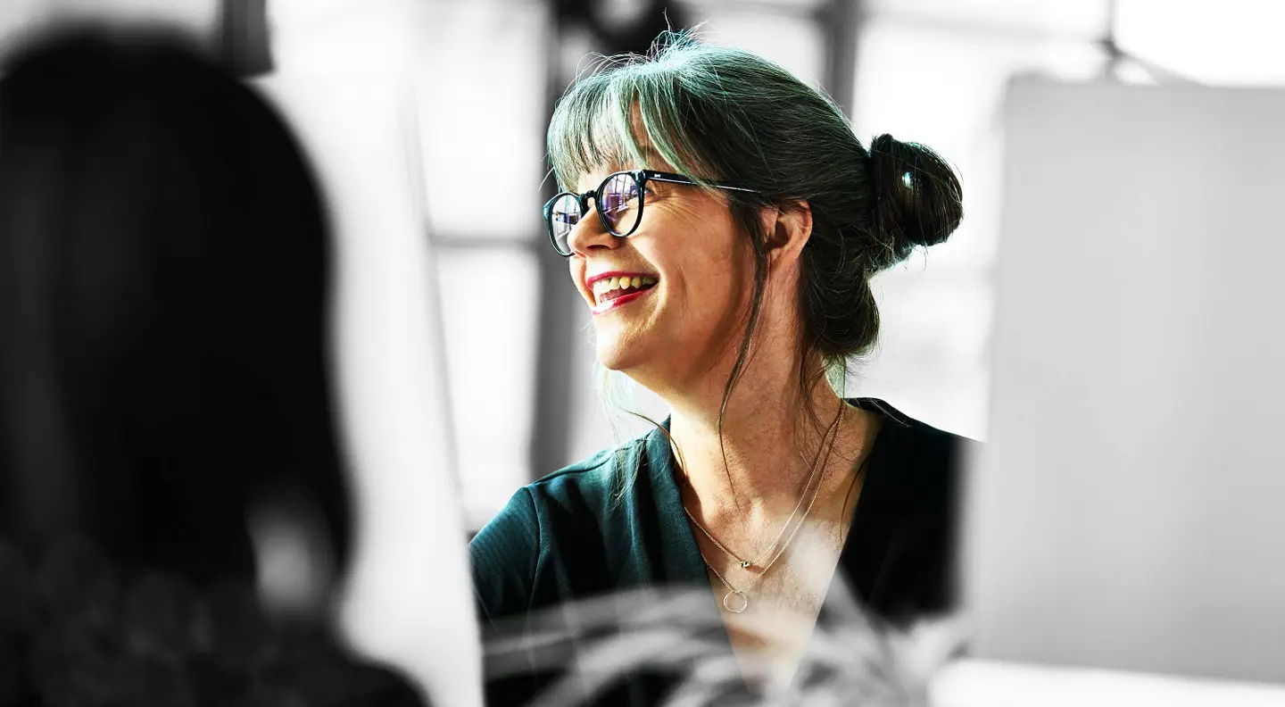 Person smiling at desk 