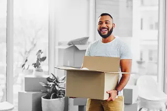 Smiling person moving into new home