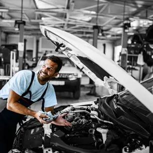 Two mechanics working on a car