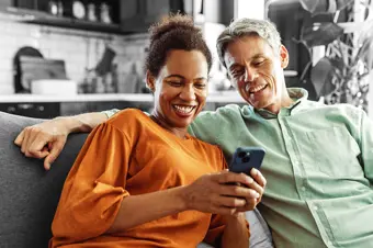 Smiling couple looking at something on a phone
