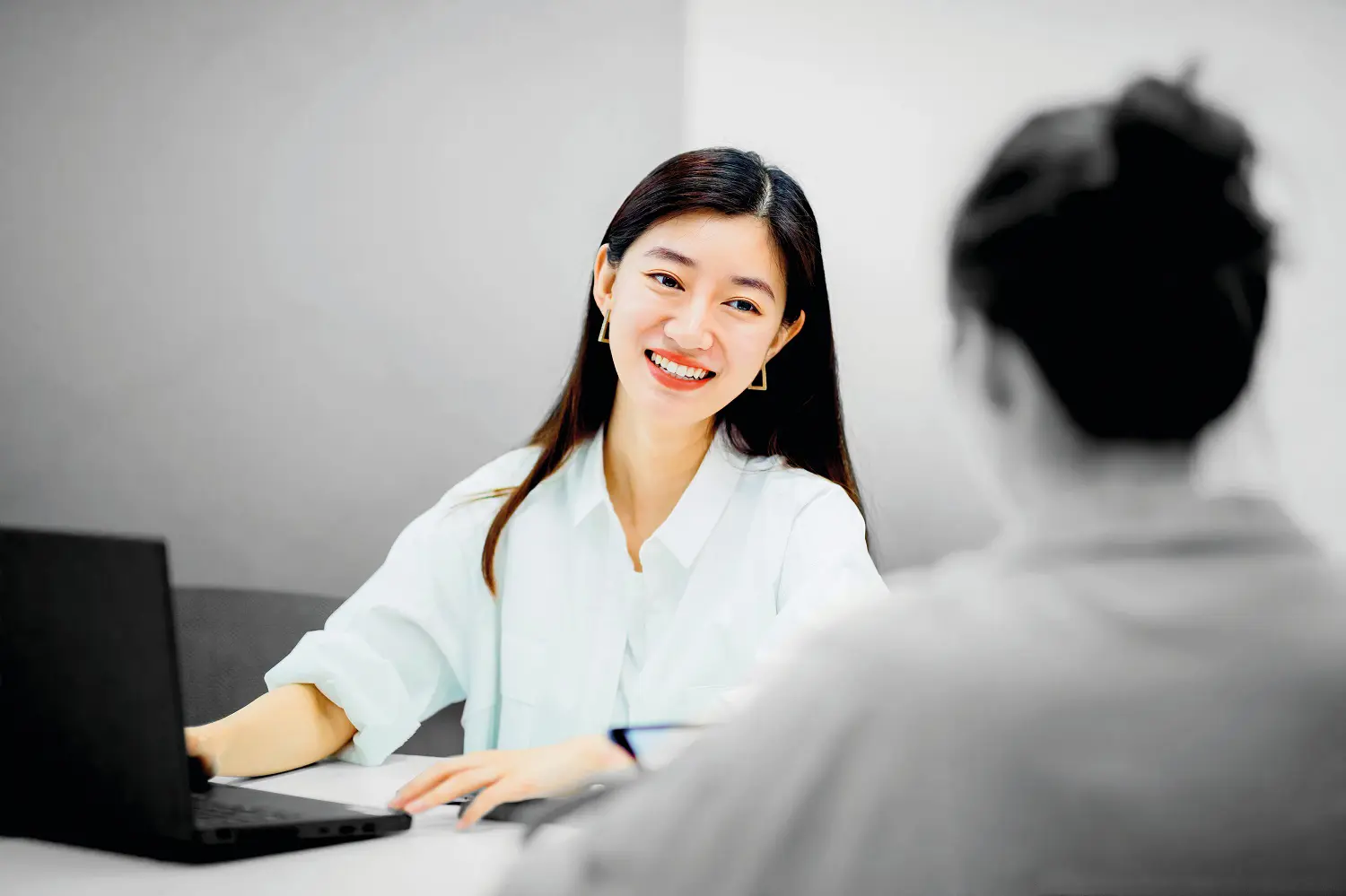 Person smiling at desk 