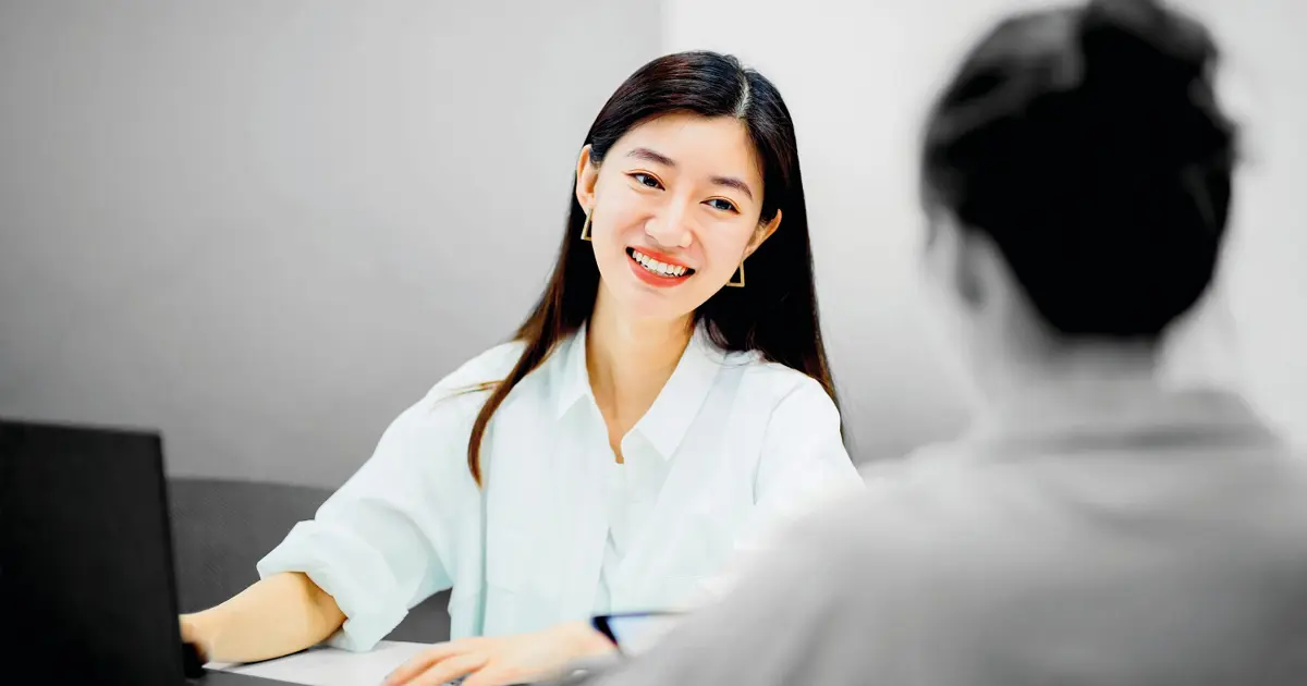 Person smiling at desk 