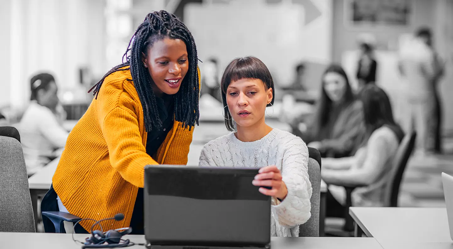 Two females at laptop in an office
