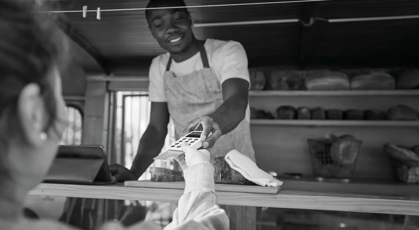 Person paying at bakery using contactless 