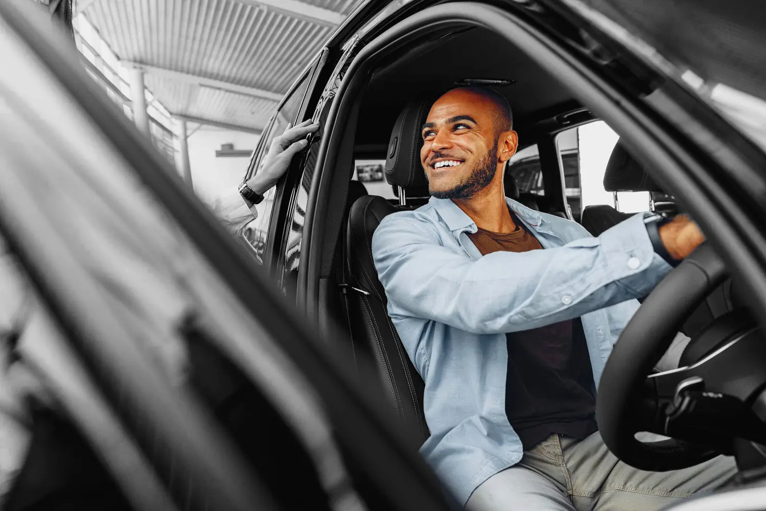 Person trying out a car in dealership