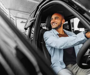 Person trying out a car in dealership