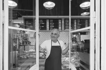 Business owner looking out of shop window 