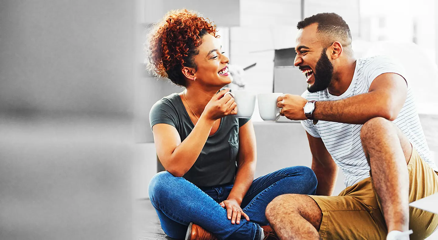 A couple on the floor, having a drink