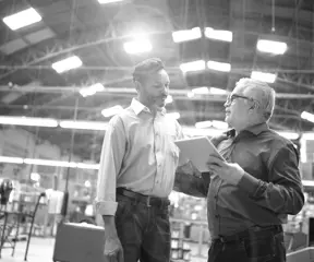 Colleagues talking at factory 