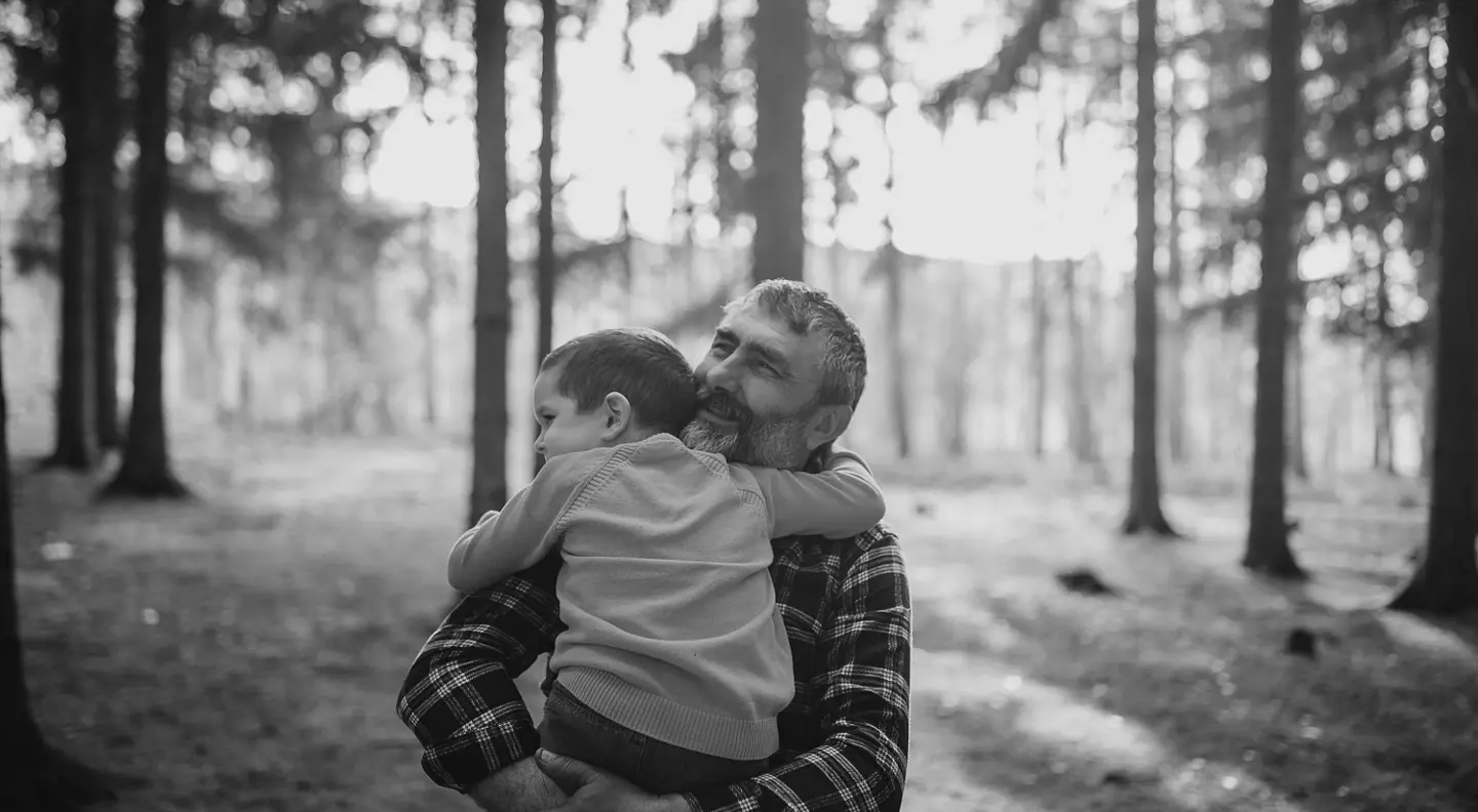 Dad holding child in arms 